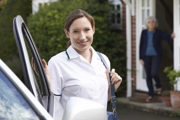 Female Care Worker Visiting Senior Woman At Home home health care provider insurance